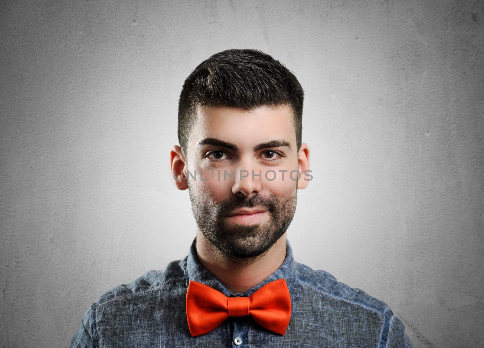 Portrait of young handsome man with red bowtie