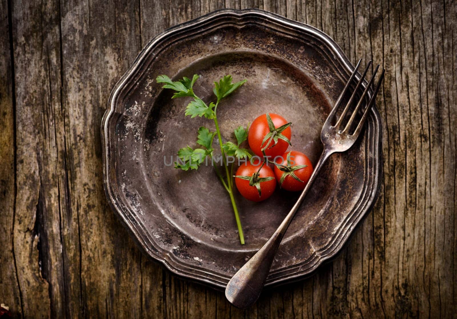 Vintage silver plate and fork on aged wooden background