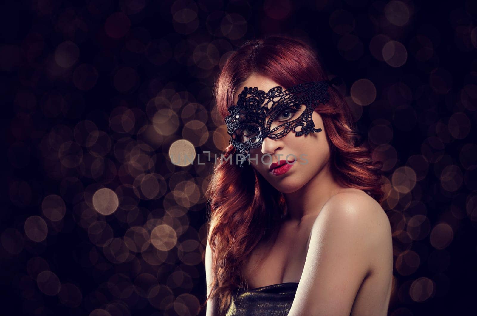 Beautiful redhead woman with black laced mask. Retro filter.