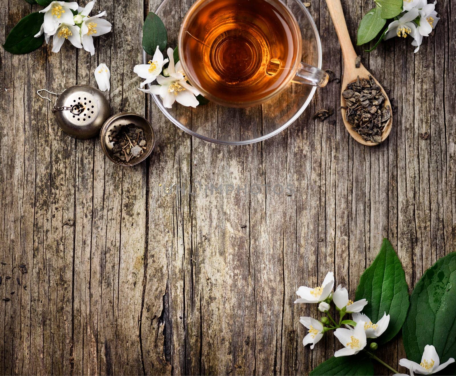 Green and jasmine tea cup on vintage wooden table
