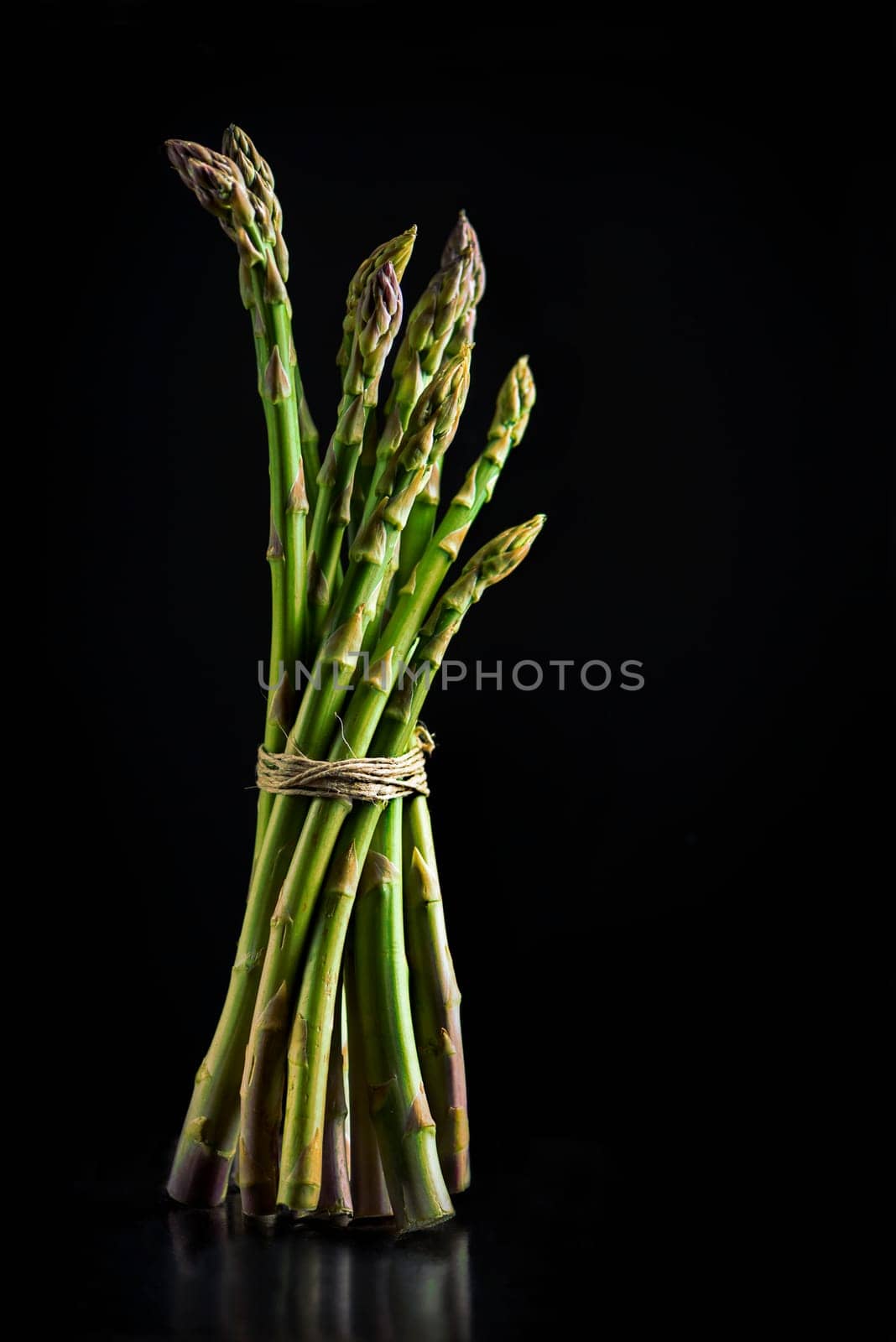 Fresh asparagus on black background