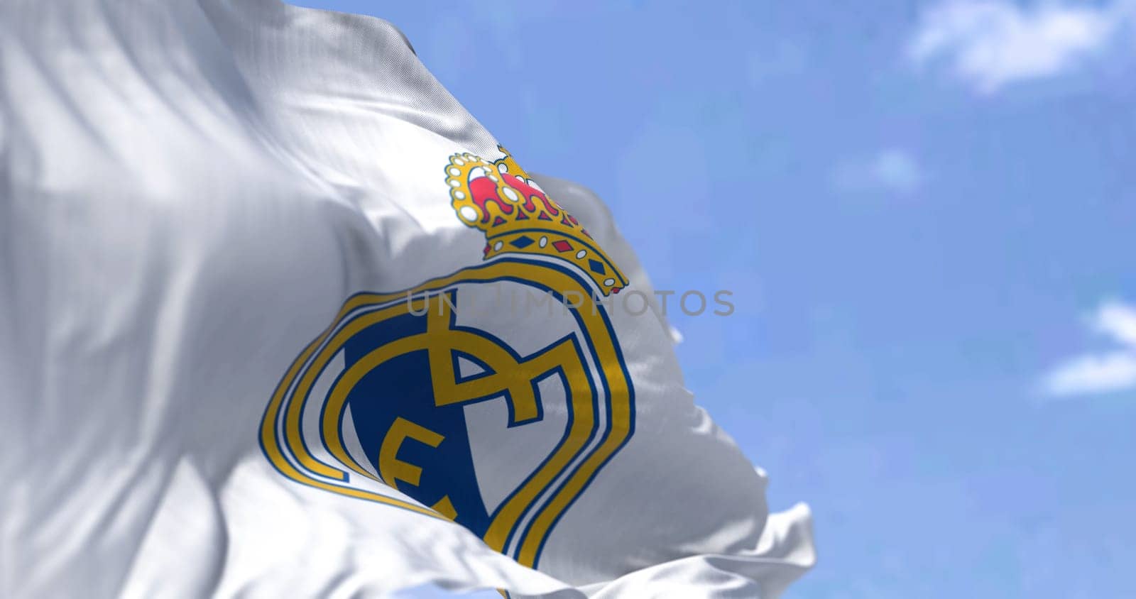 Madrid, Spain, May 2022: The flag of Real Madrid Club de Fútbol waving in the wind on a clear day. Real Madrid C.F. is a Spanish professional football club based in Madrid