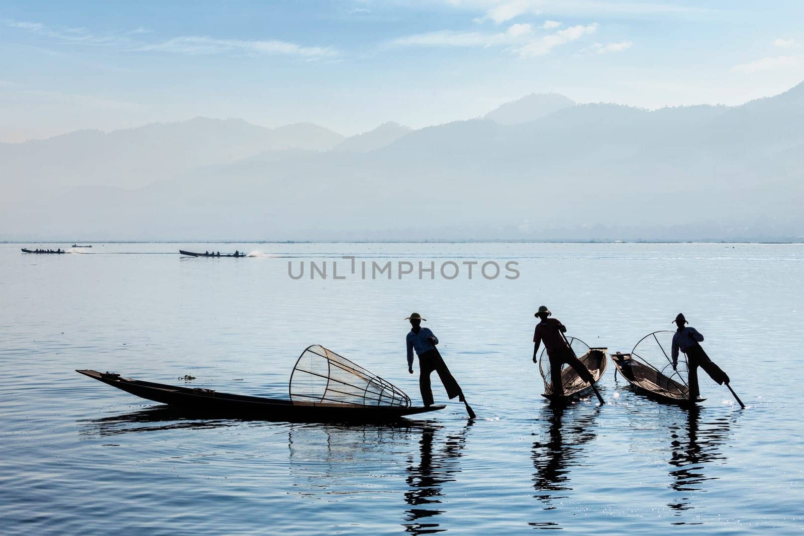 Myanmar travel attraction landmark - Traditional Burmese fisherman at Inle lake, Myanmar famous for their distinctive one legged rowing style
