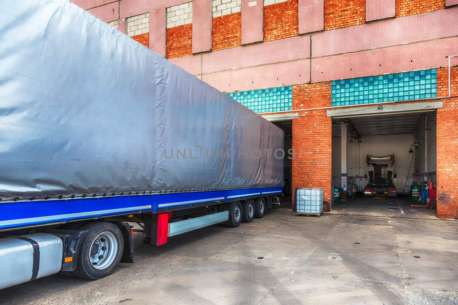 Trailer of truck or lorry near repair shop service garage