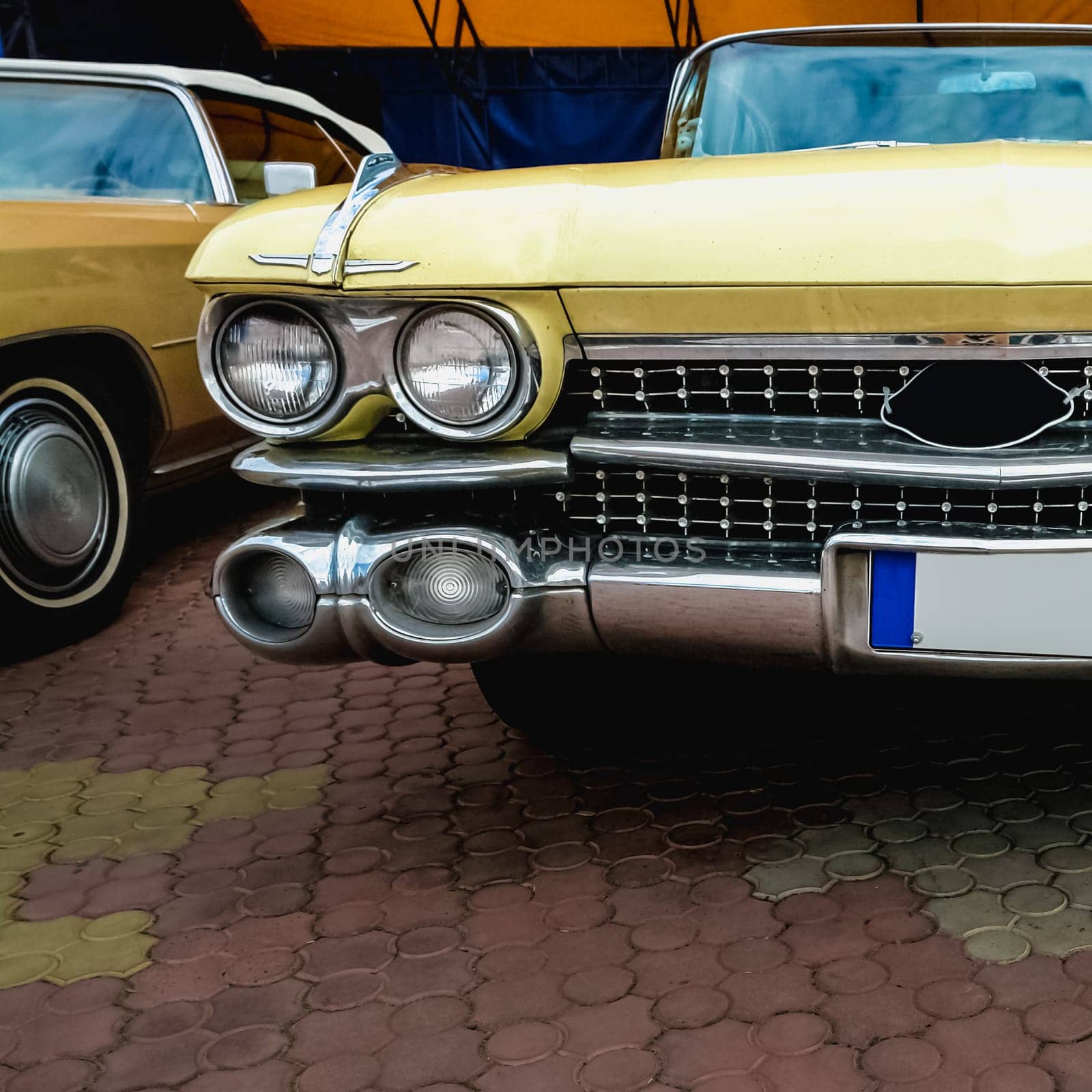 Old retro or vintage car or automobile front side with front lights or headlights and radiator grill