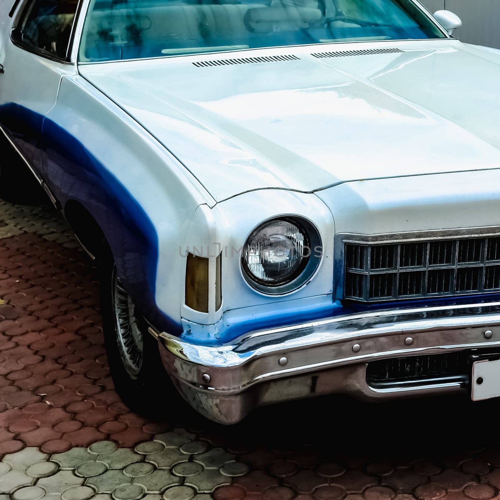 Old retro or vintage car or automobile front side with front light or headlight