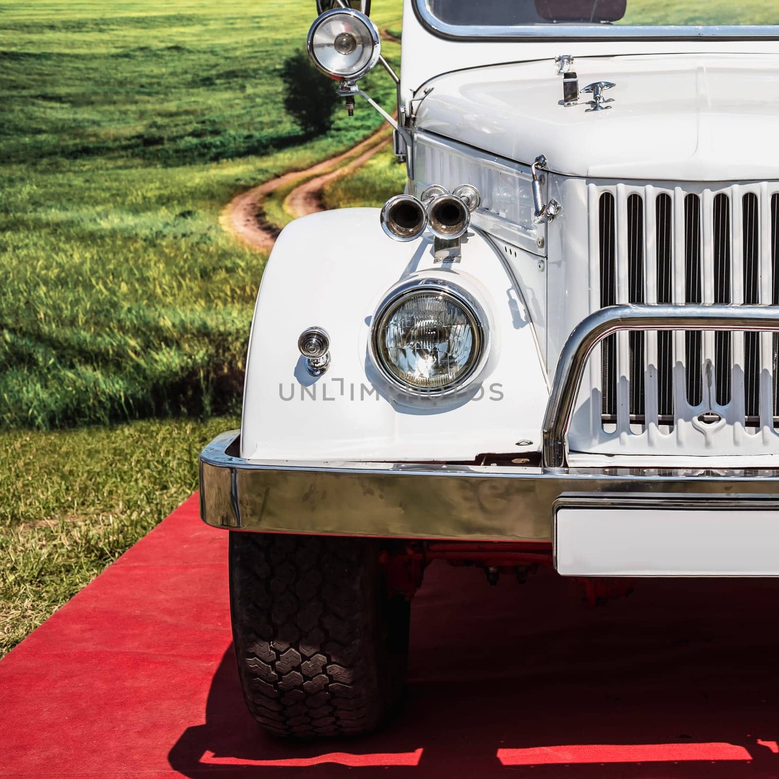 Old retro or vintage car or automobile front side with front lights or headlights and radiator grill