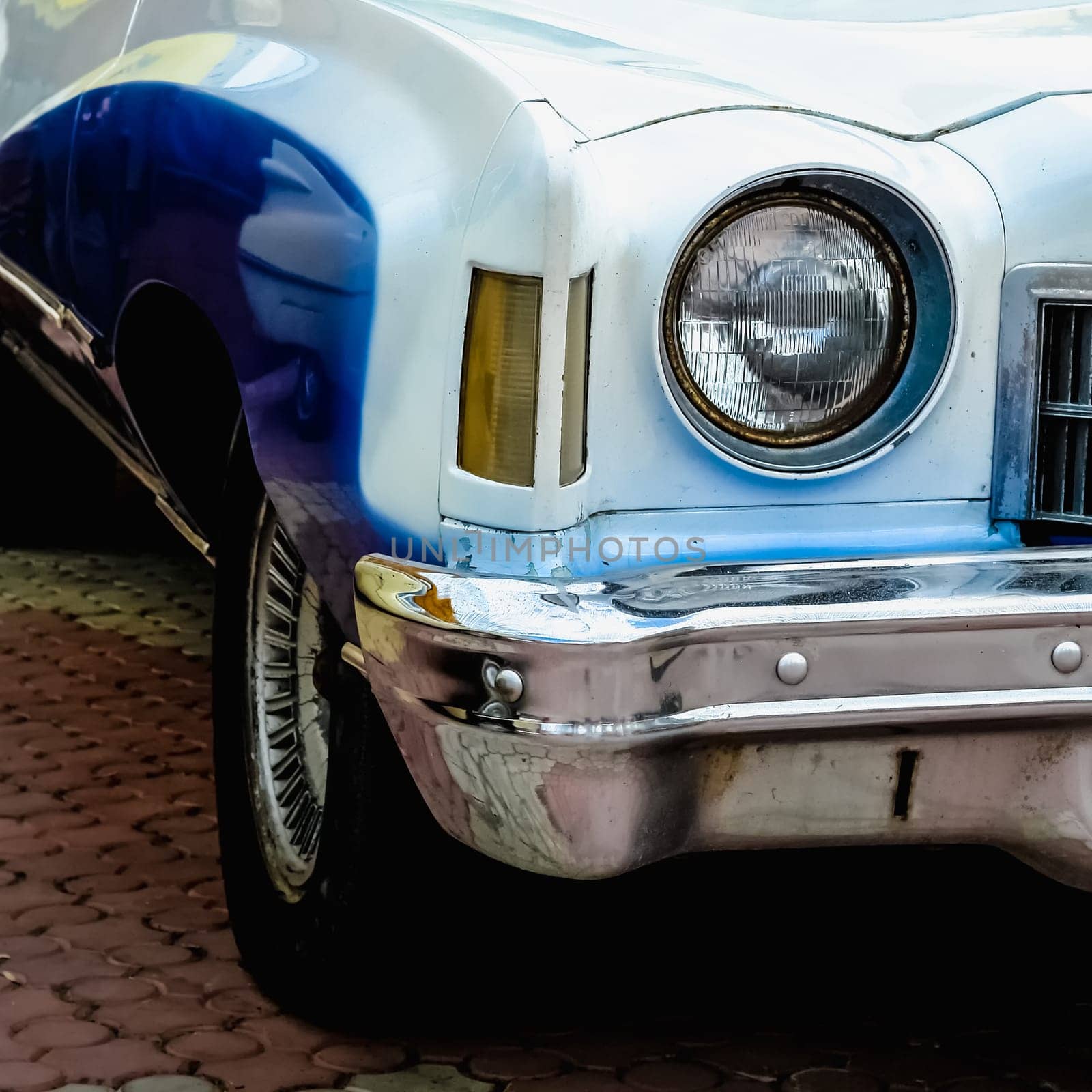Old retro or vintage car or automobile front side with front light or headlight