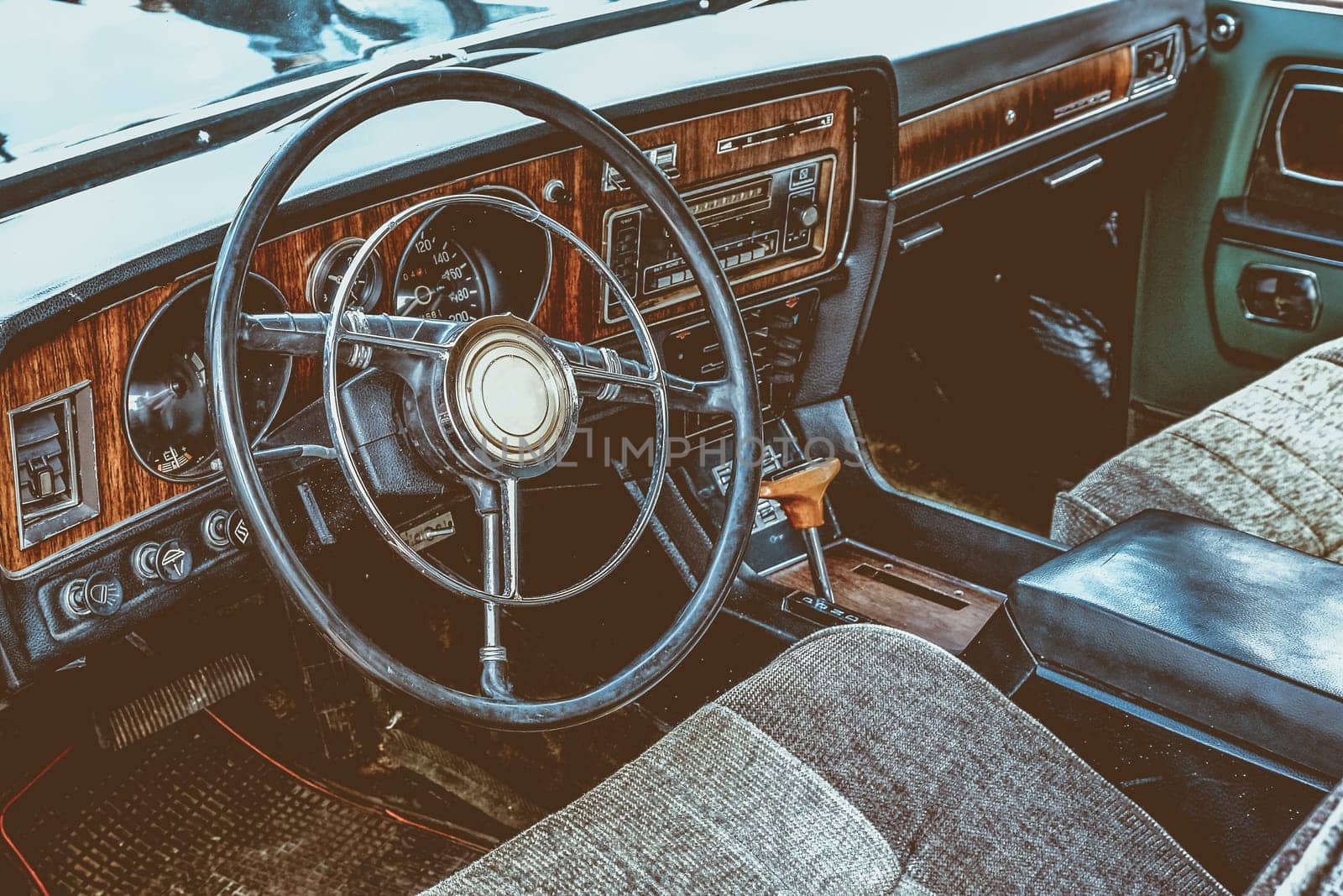 Interior of old retro vintage automobile or car with steering wheel and dashboard. Processed by vintage or retro effect filter