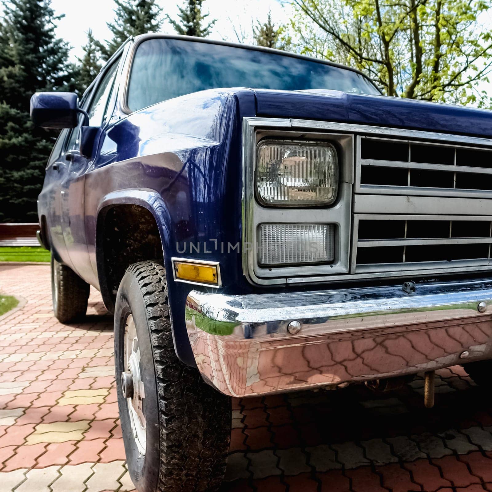 Old retro or vintage car or automobile front side with front lights or headlights and radiator grill