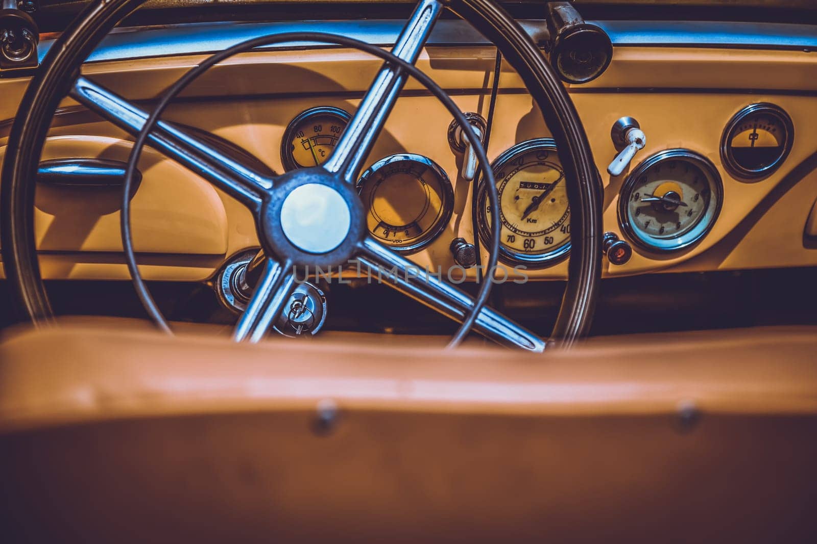 Steering wheel and dashboard in interior of old retro automobile. Processed by vintage or retro effect filter