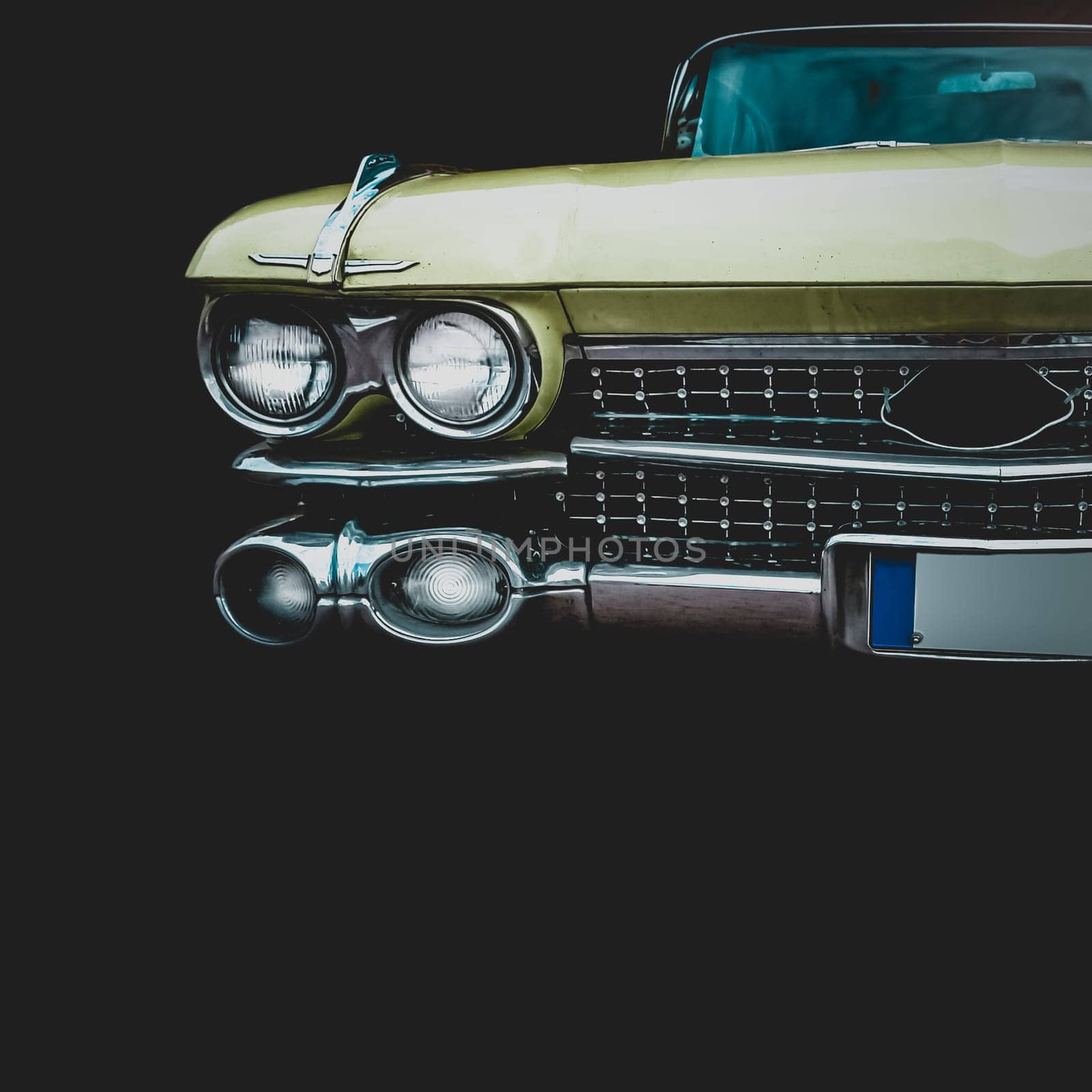 Old retro or vintage car or automobile front side with front lights or headlights and radiator grill. Processed by vintage or retro effect filter