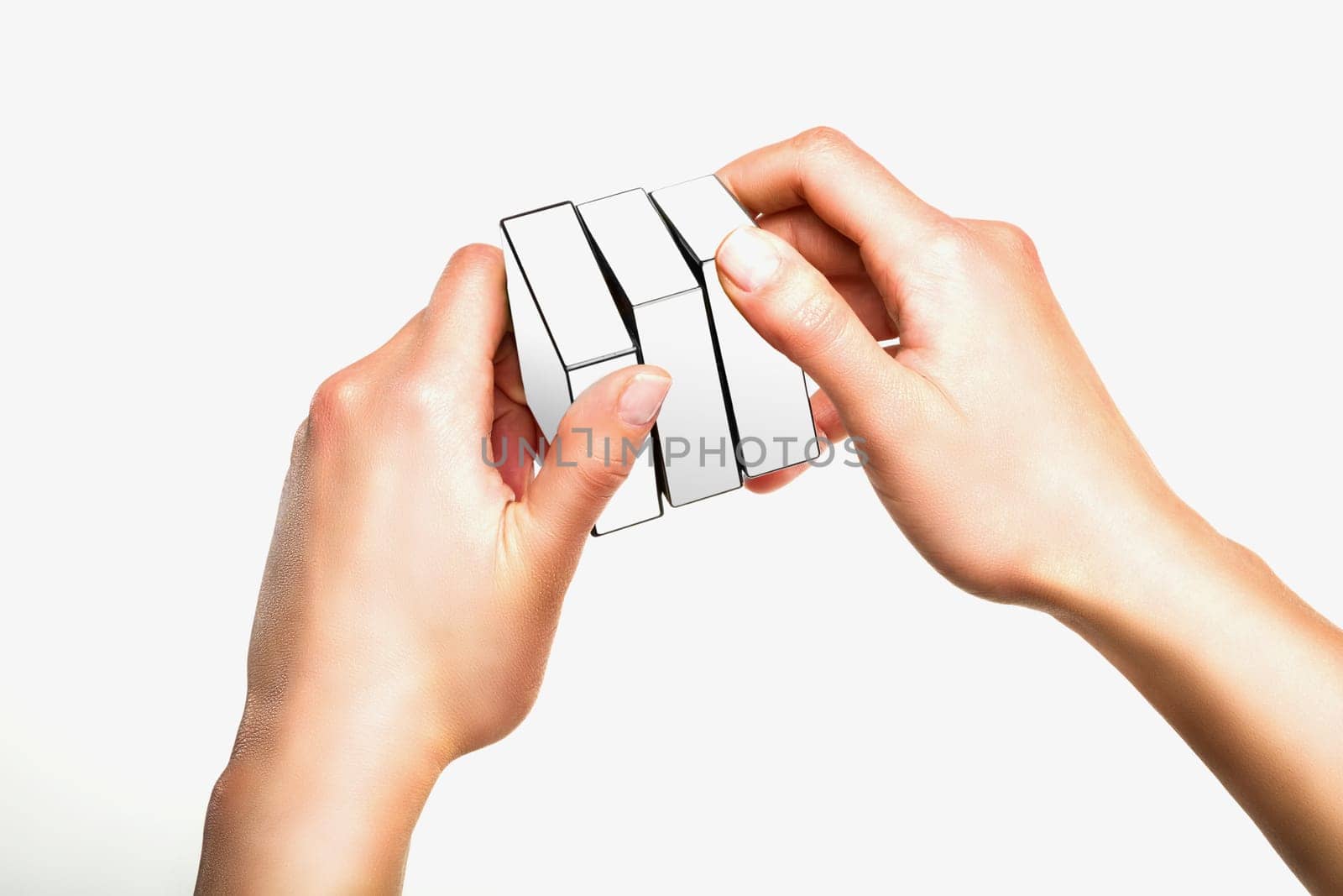 Hands holding or playing with white cube on white background