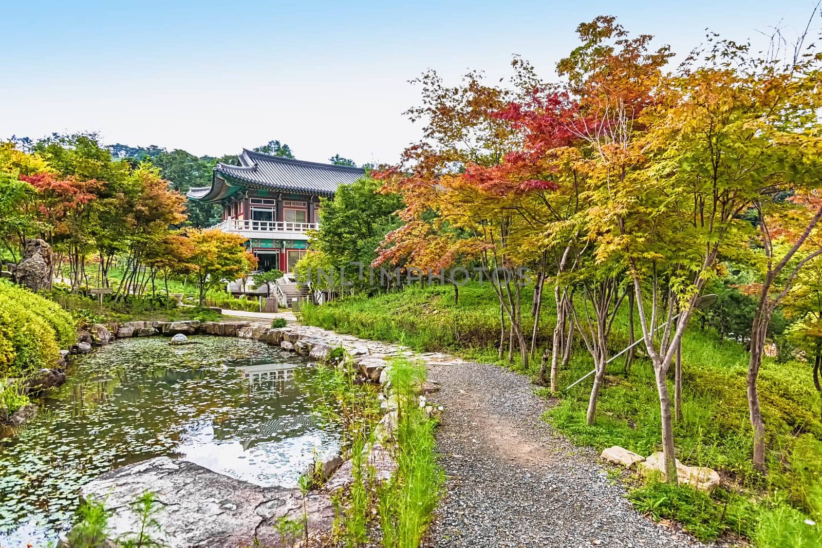 Traditional korean architecture old building or monks temple with little pond in South Korea at autumn
