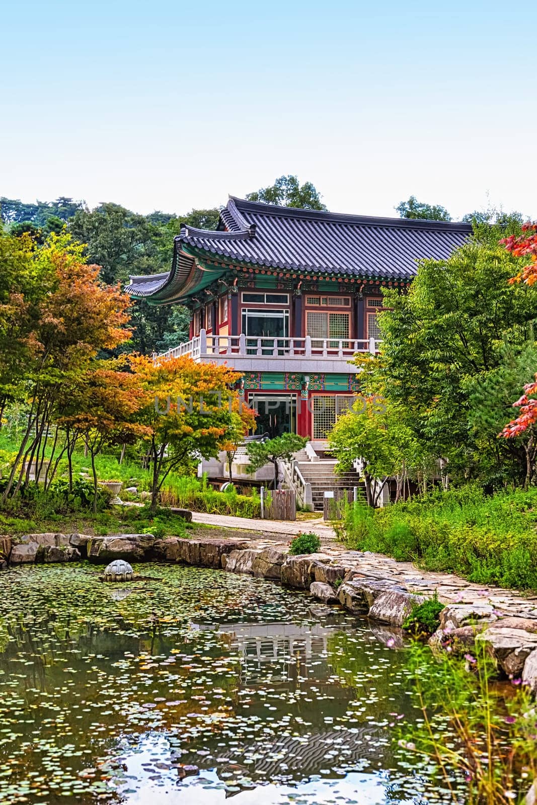 Traditional korean architecture old building or monks temple with little pond in South Korea at autumn