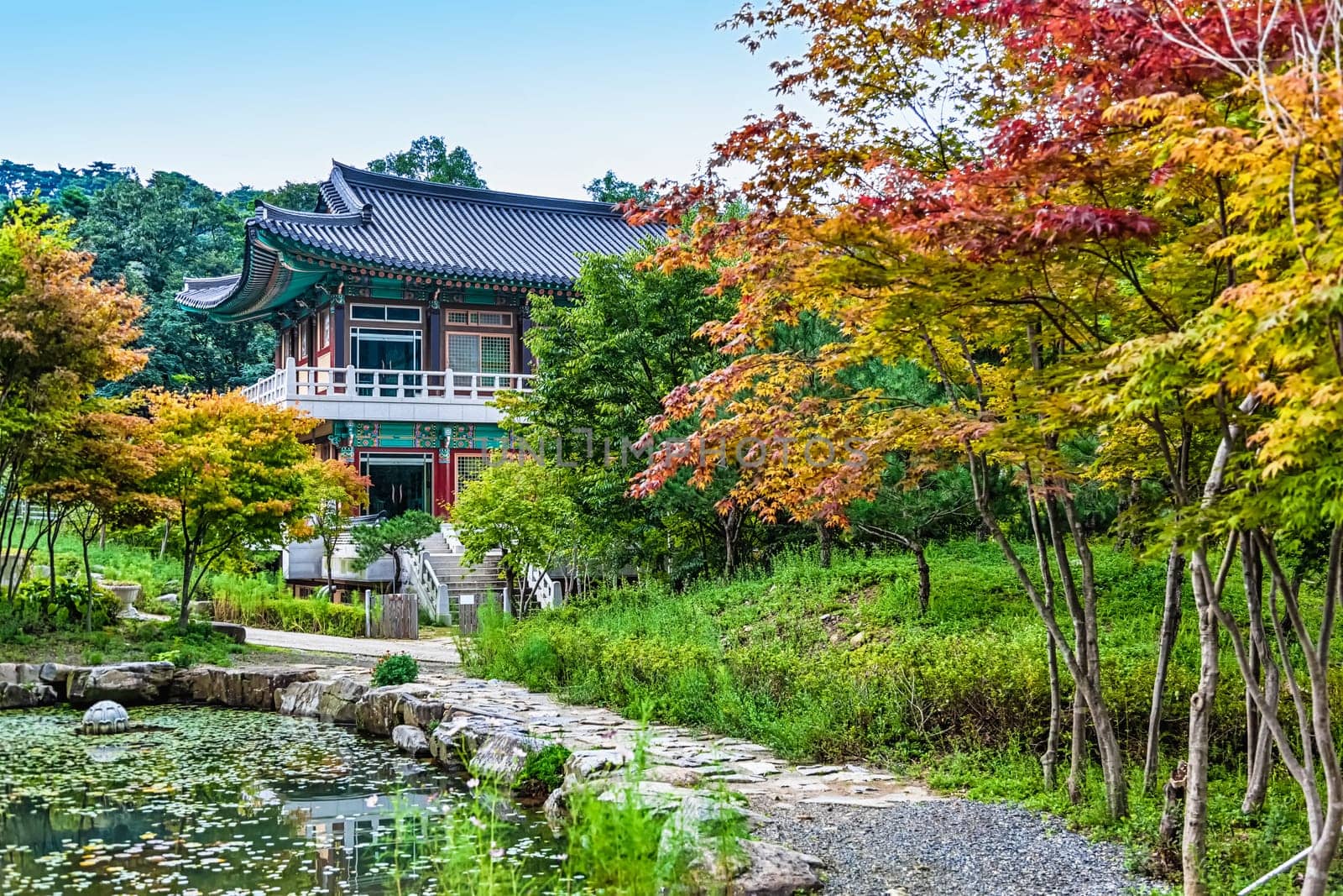 Traditional korean architecture old building or monks temple with little pond in South Korea at autumn