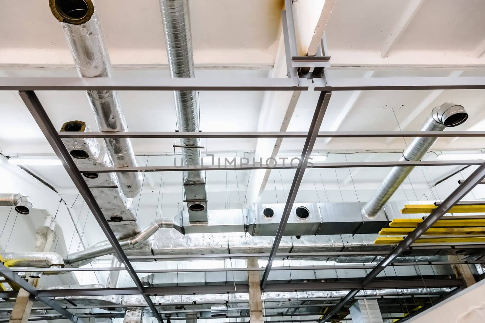 Rooftop with pipes of industrial building under construction