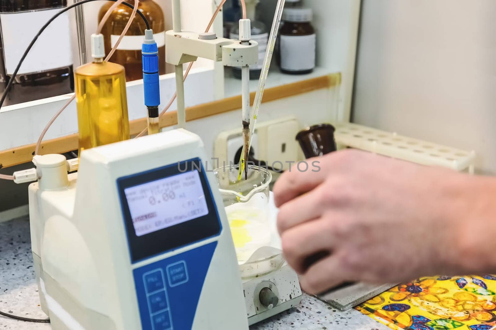 Laborant makes test in research laboratory with electronic measuring equipment on pharmaceutical industry manufacture or chemical plant