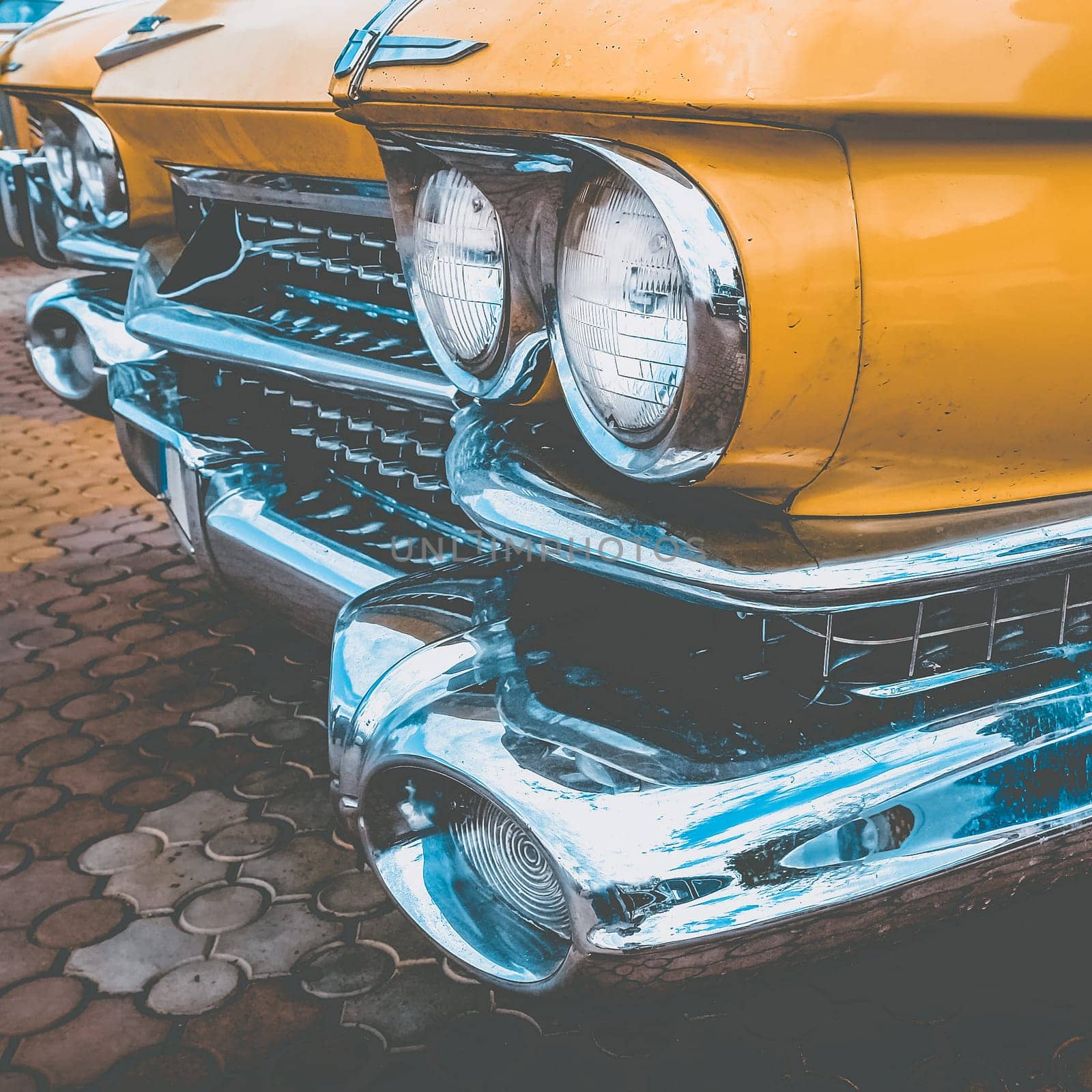 Old retro or vintage car or automobile front side with front lights or headlights and radiator grill. Processed by vintage or retro effect filter
