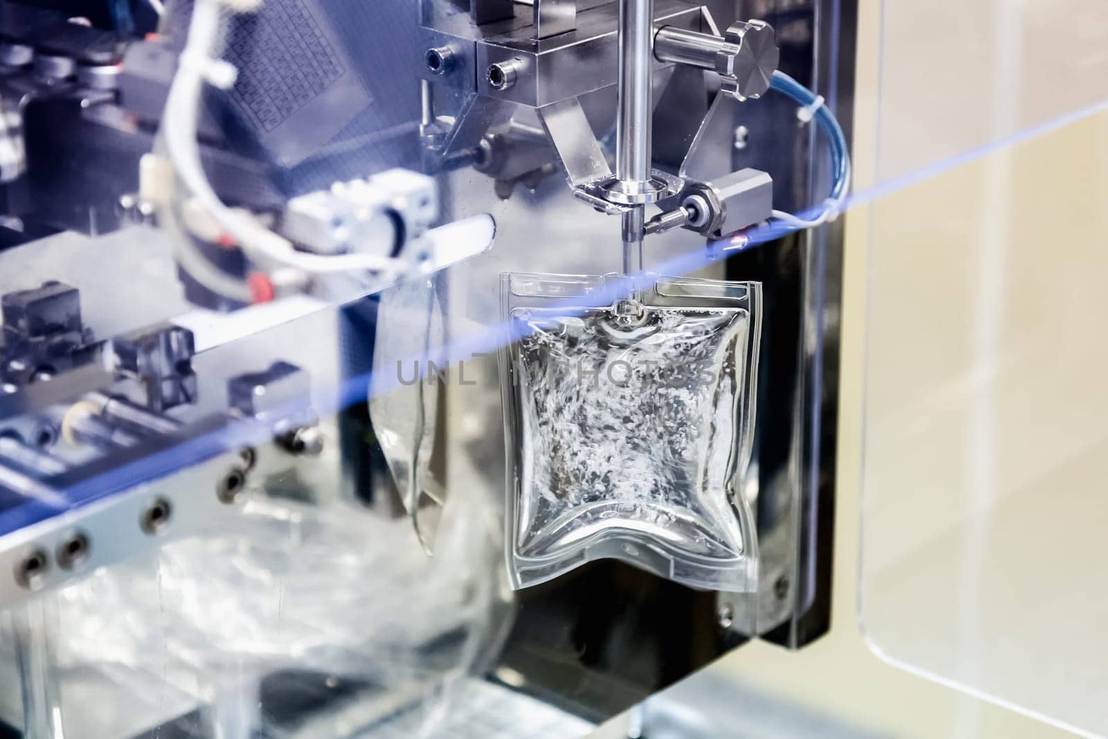 Machine filling liquid substance in transparent package on pharmaceutical industry manufacture or chemical plant