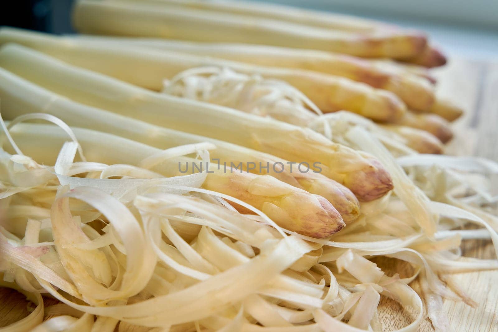 Fresh peeled white asparagus directly from the field on a kitchen table
