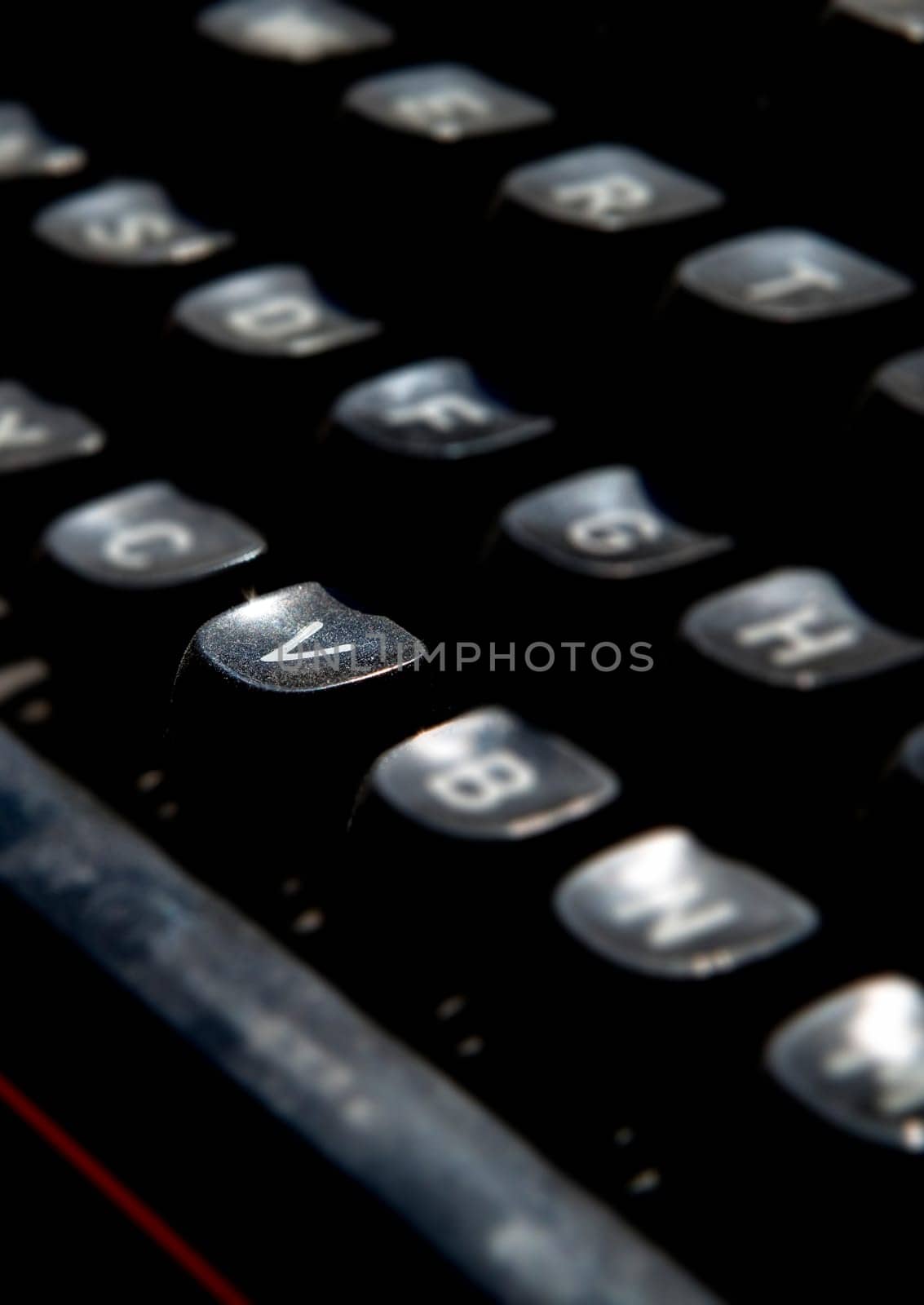 1970s dusty typewriter. Selective focus on key V