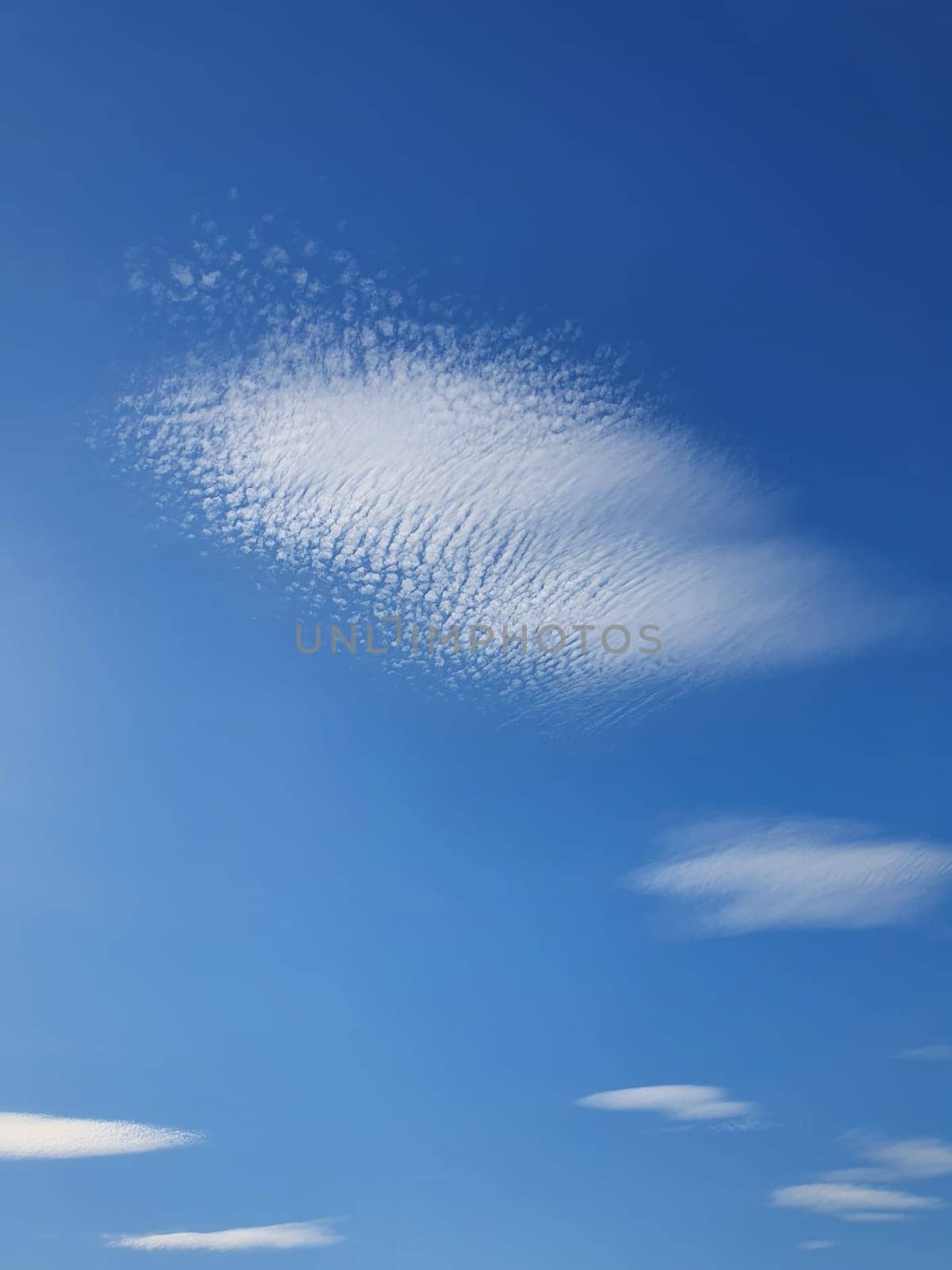 Abstract cirrus clouds on the blue sky background. Beautiful cloudscape scene