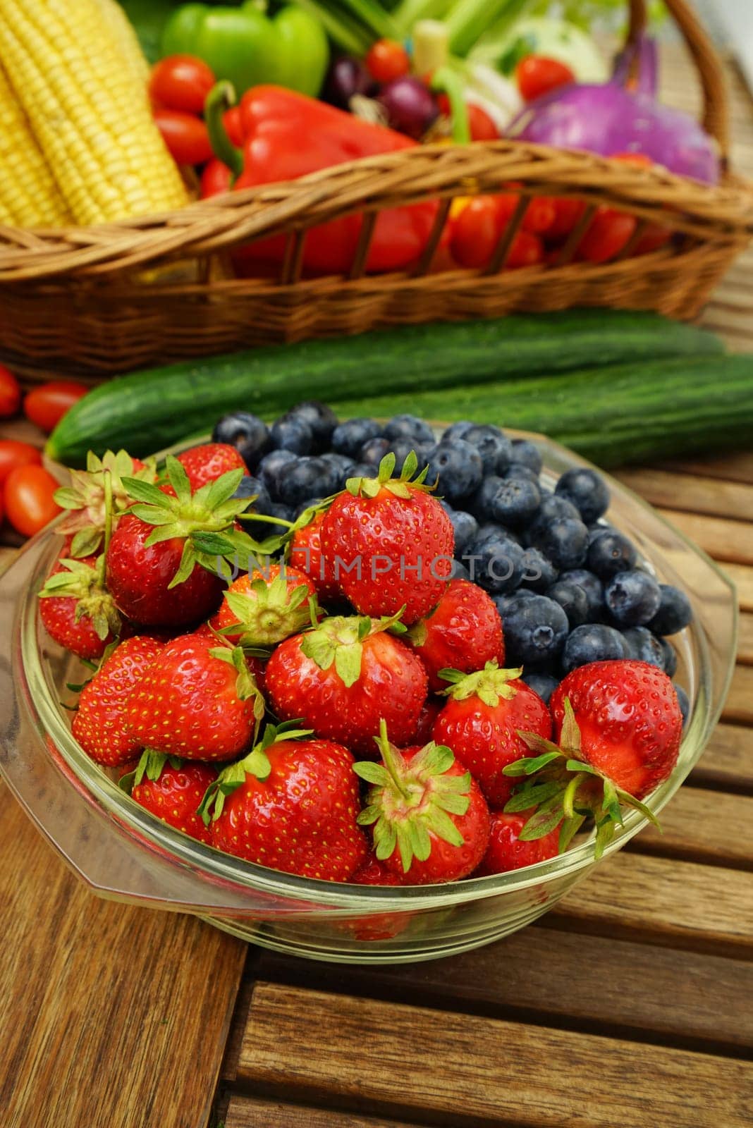 Fresh healthy strawberries and other fruits on a wooden table