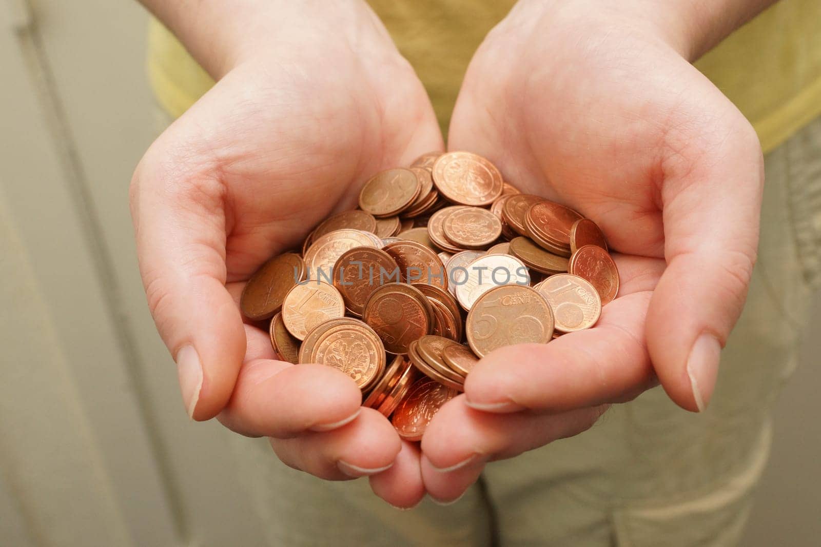 Many euro cent coins in woman hand