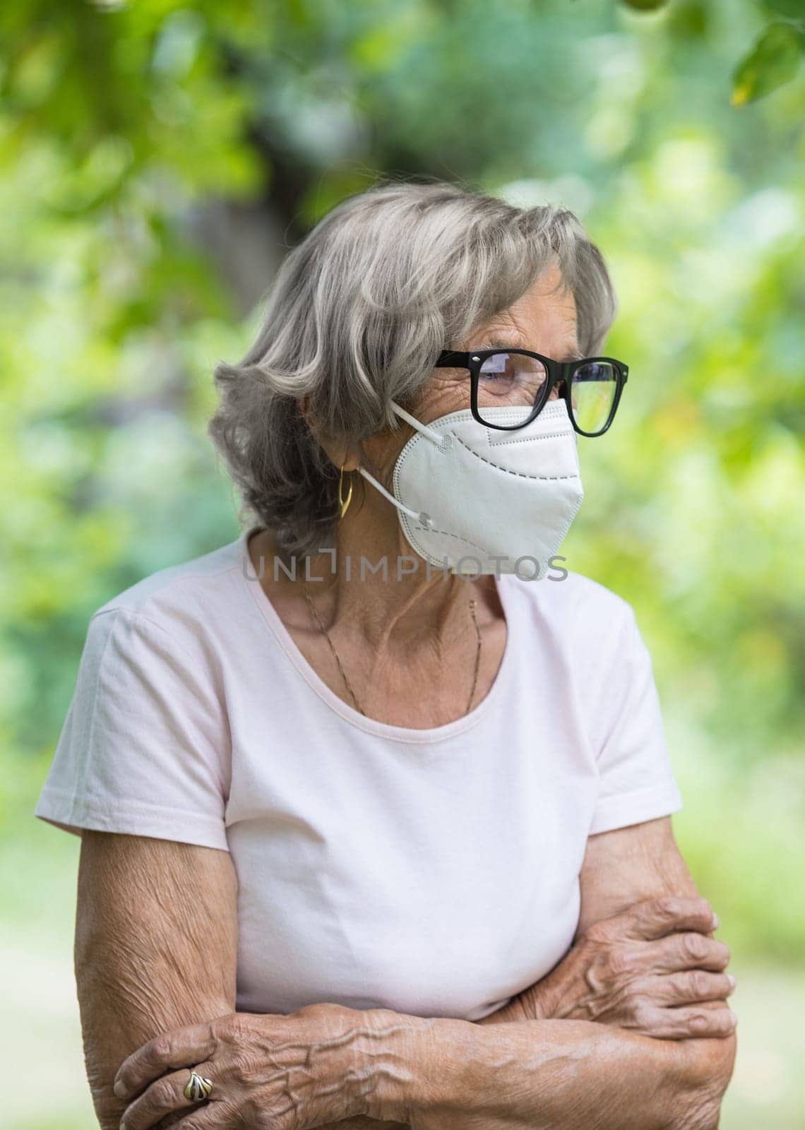 Elderly woman wearing a protective face mask against corona virus