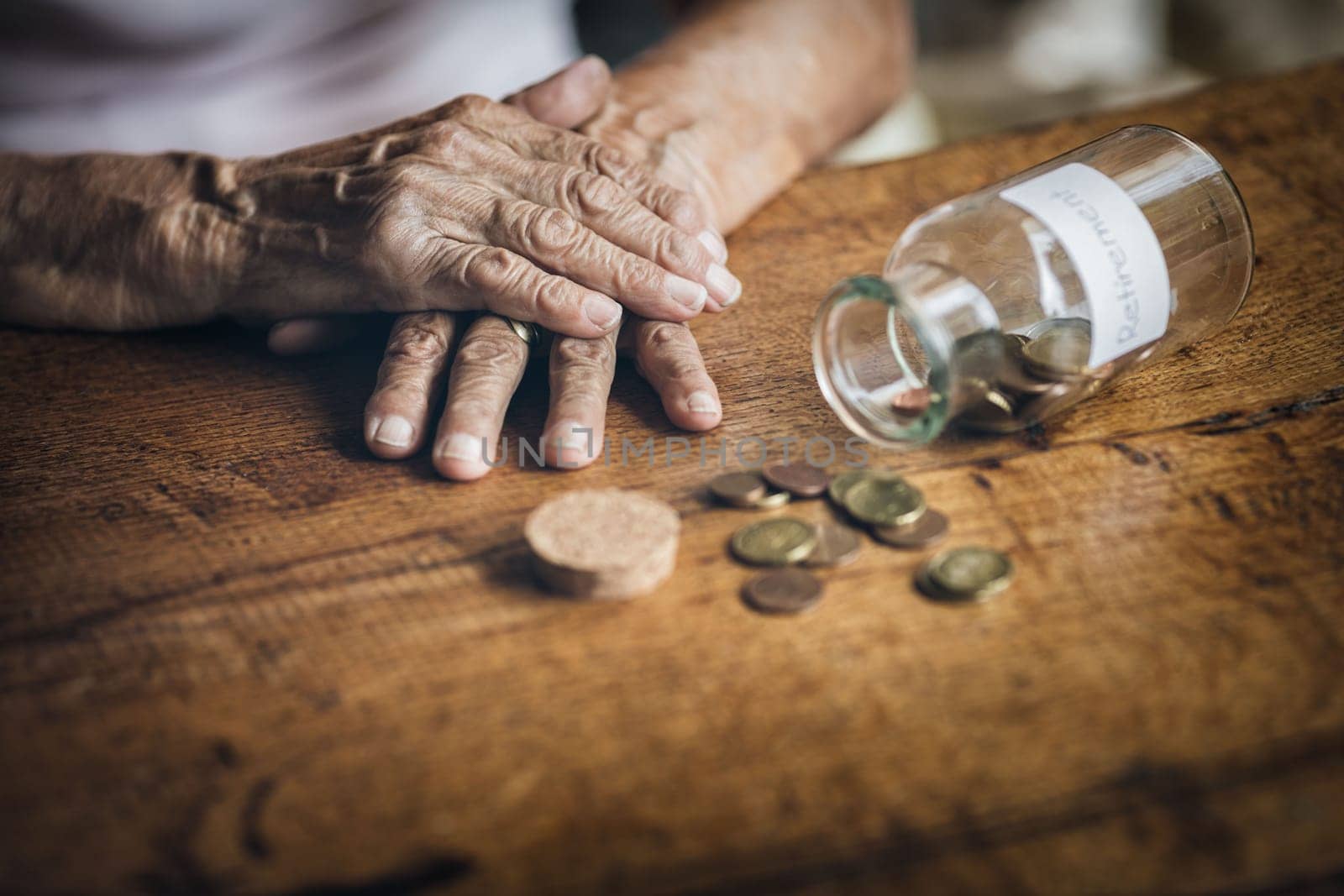 Elderly retired woman and her savings in a jar