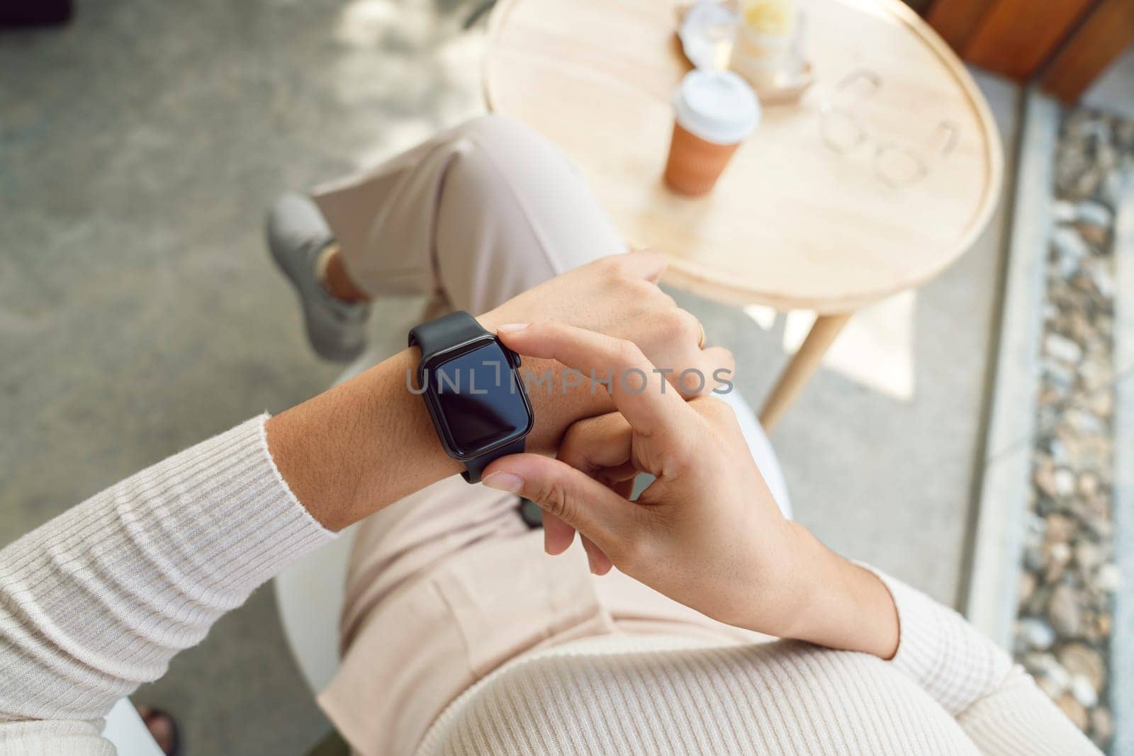 women checking smartwatch on her hand