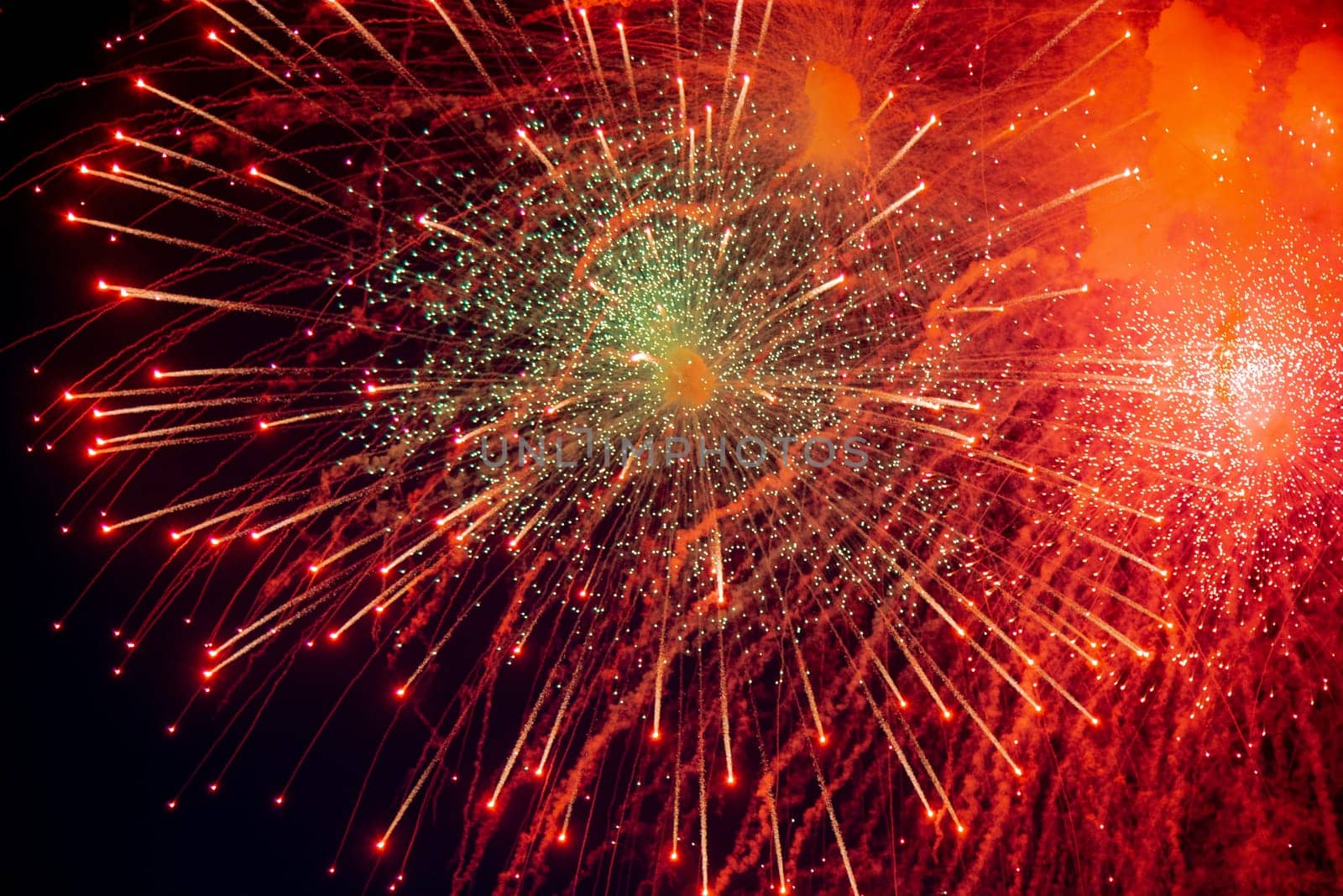A large red salute with green specks in the center and flying stars in different directions. High quality photo