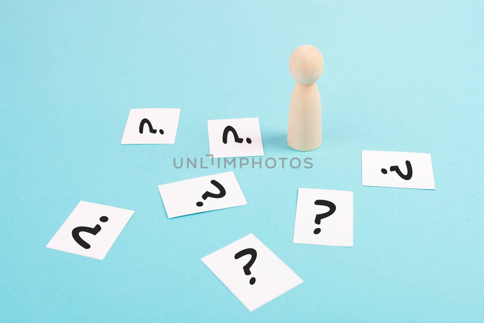 Man is thinking, question marks, brainstorming and looking for answers, solving a problem, making a decision, business and education concept