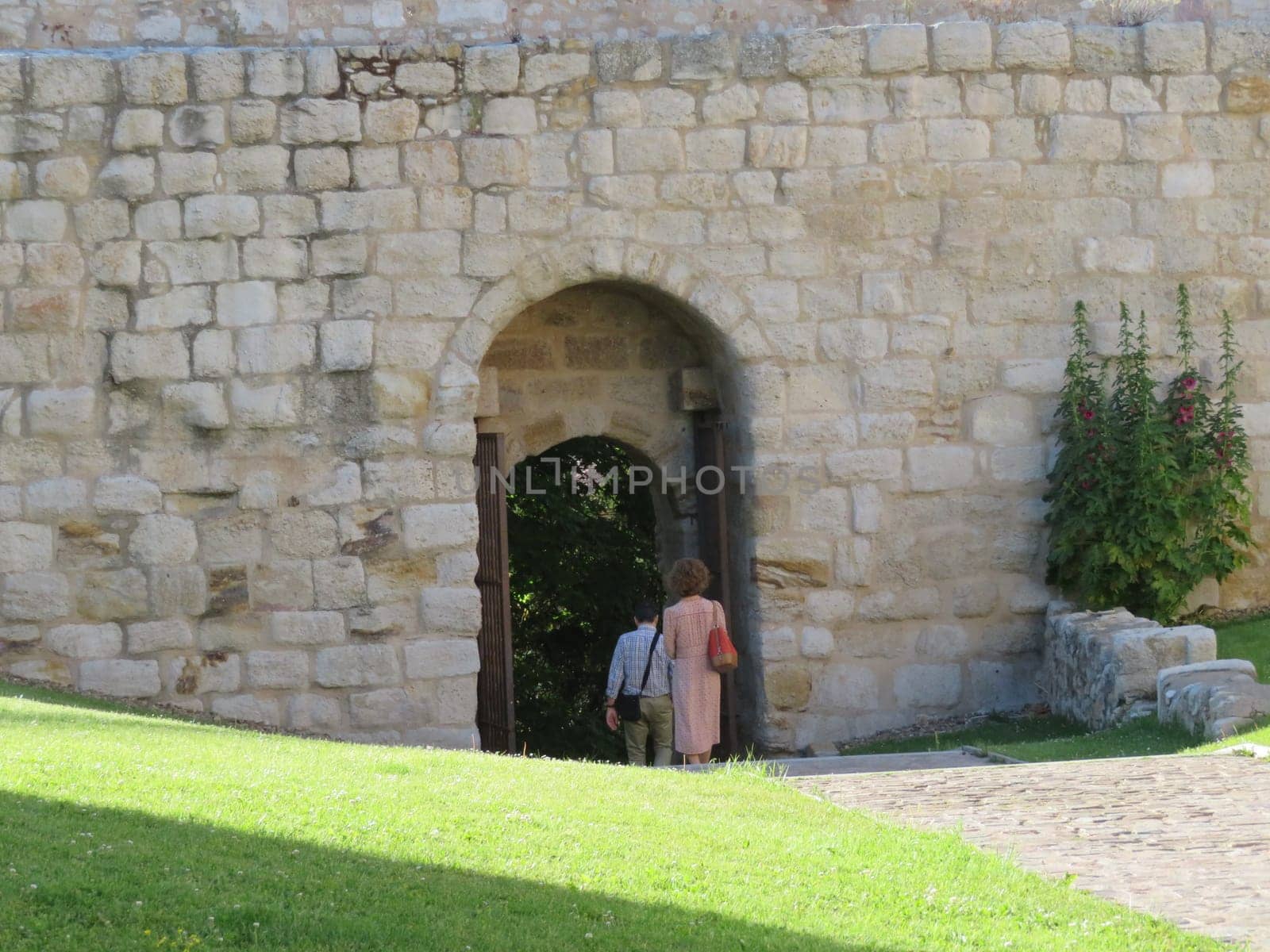 people leaving through the gate of the ancient tradition wall