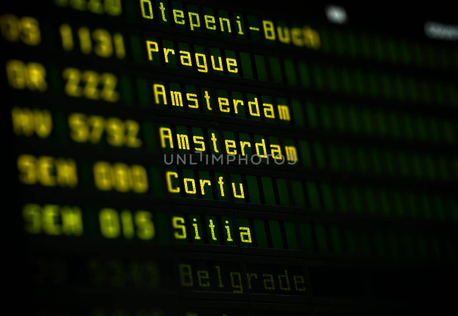 Flight information board at airport terminal closeup.