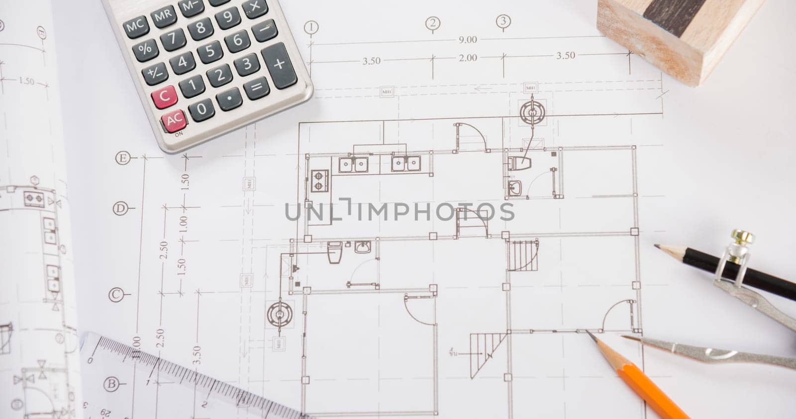 Architectural project workplace. Top view of house plan blueprint paper with repair tools on table desk at architecture office, Engineering architect design tools concept