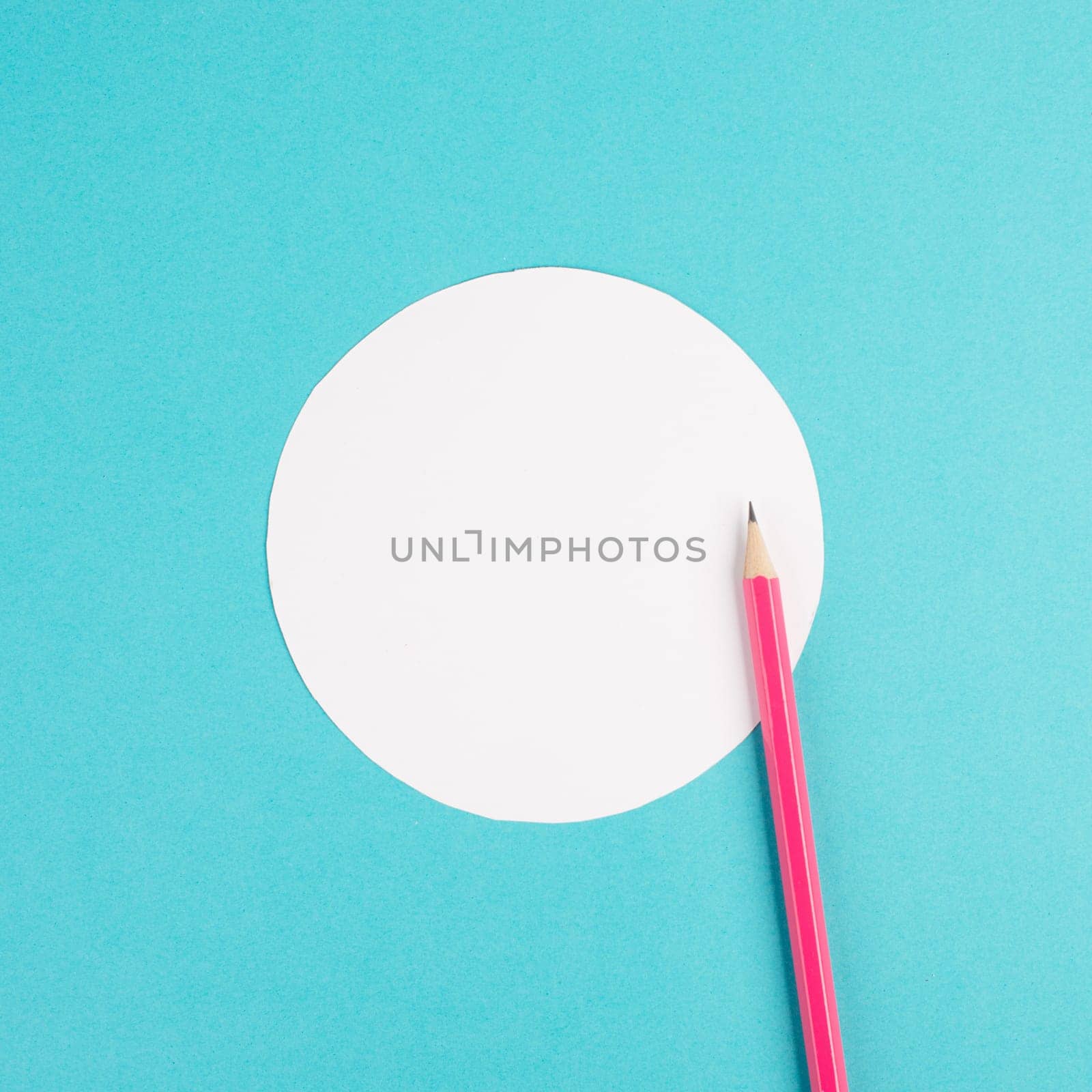 Pencils on a blue paper background, white circle frame with copy space for text, minimalism, creative and business concept, pastel colored