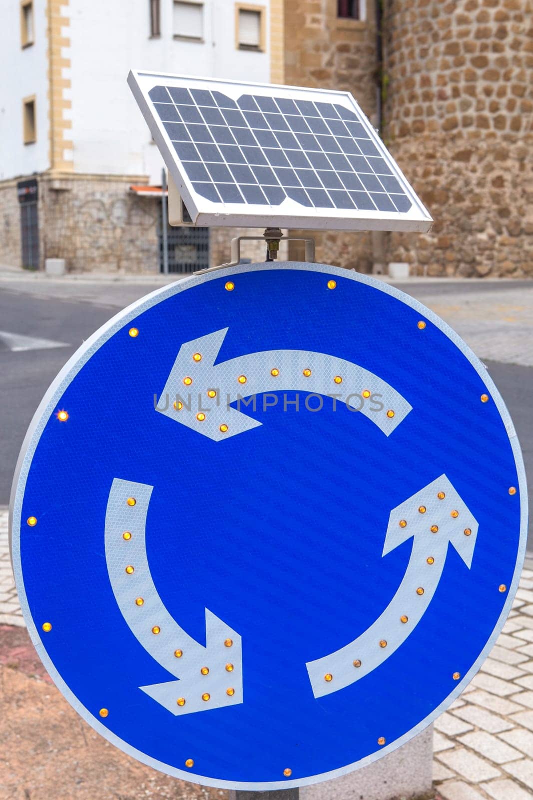 Roundabout sign powered by solar panel. Environmentally friendly traffic signs