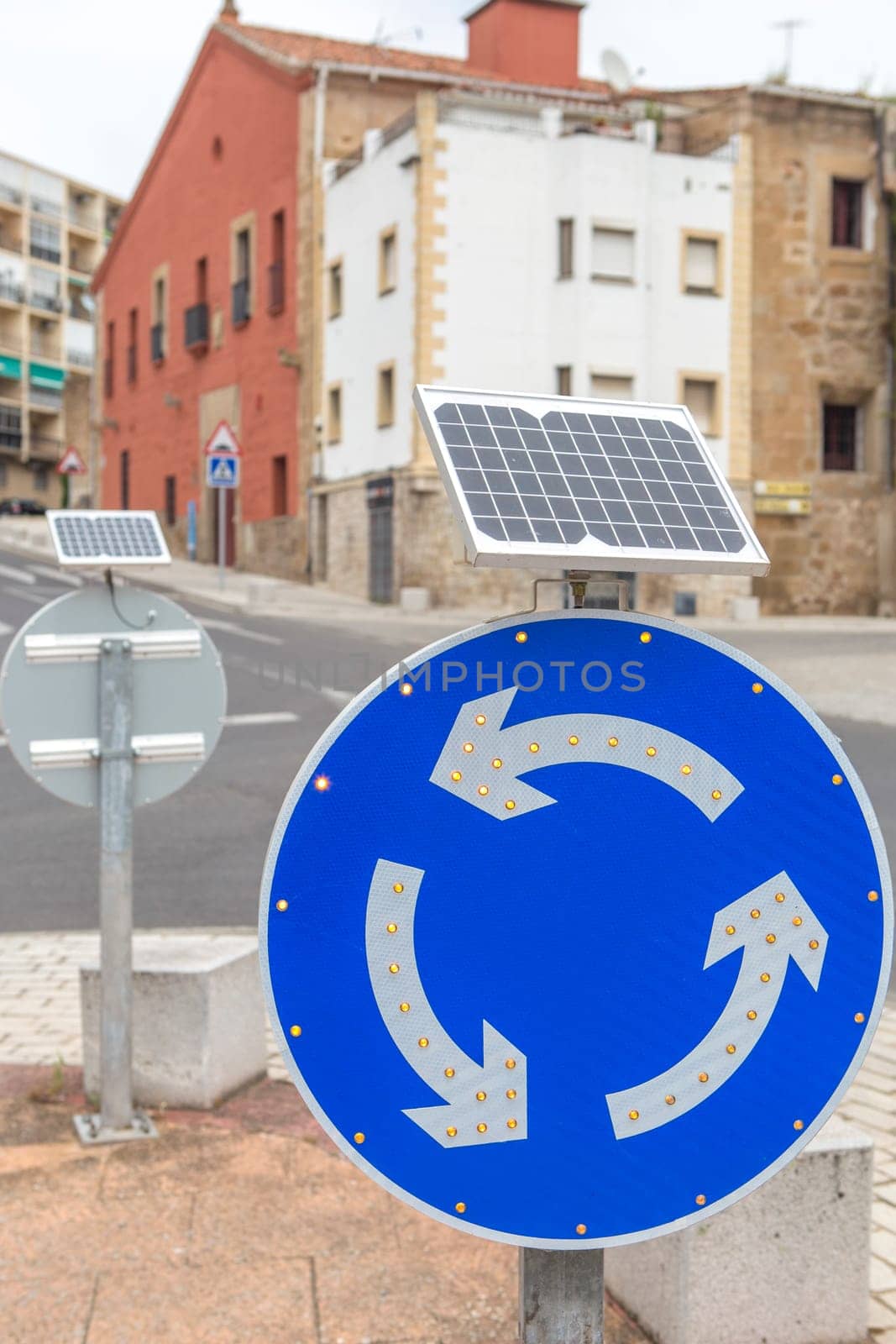 Roundabout sign powered by solar panel. Environmentally friendly traffic signs