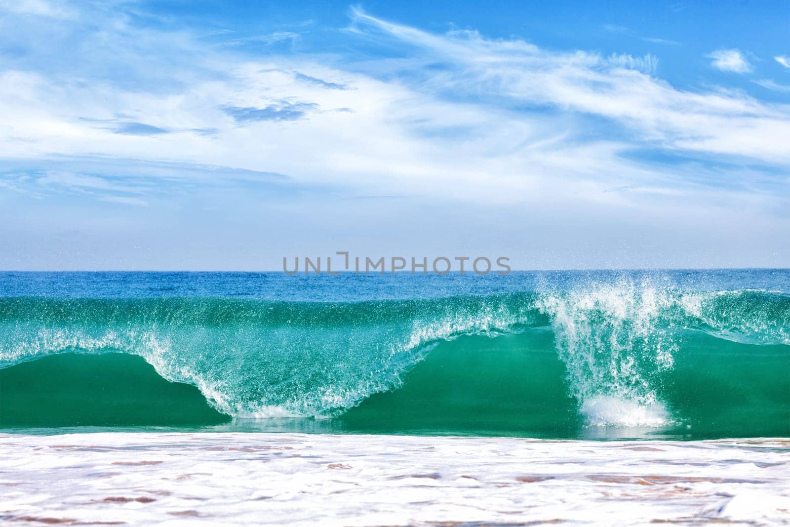 Big wave in ocean with blue sky