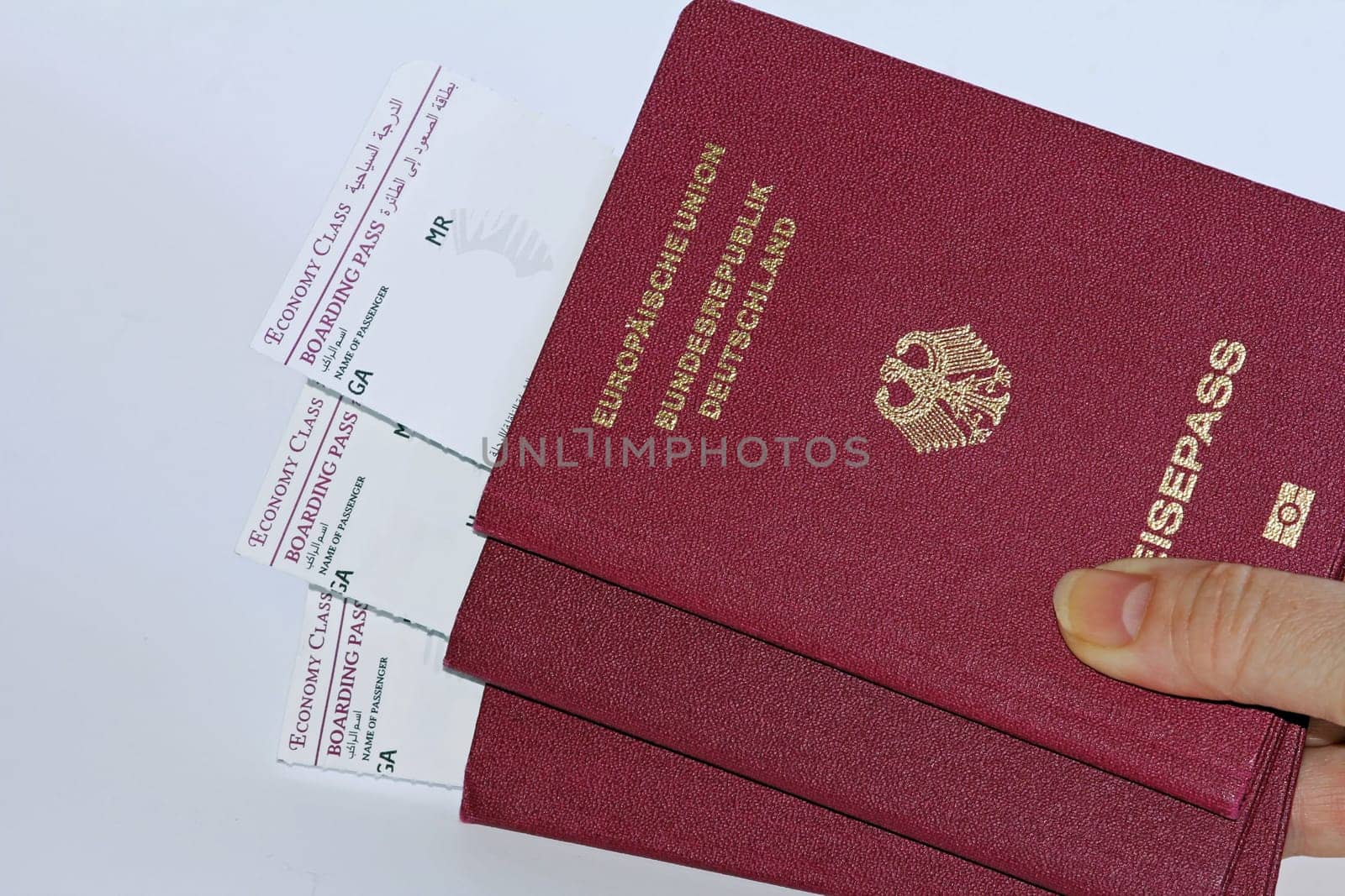 Three German passports and boarding passes for air travel