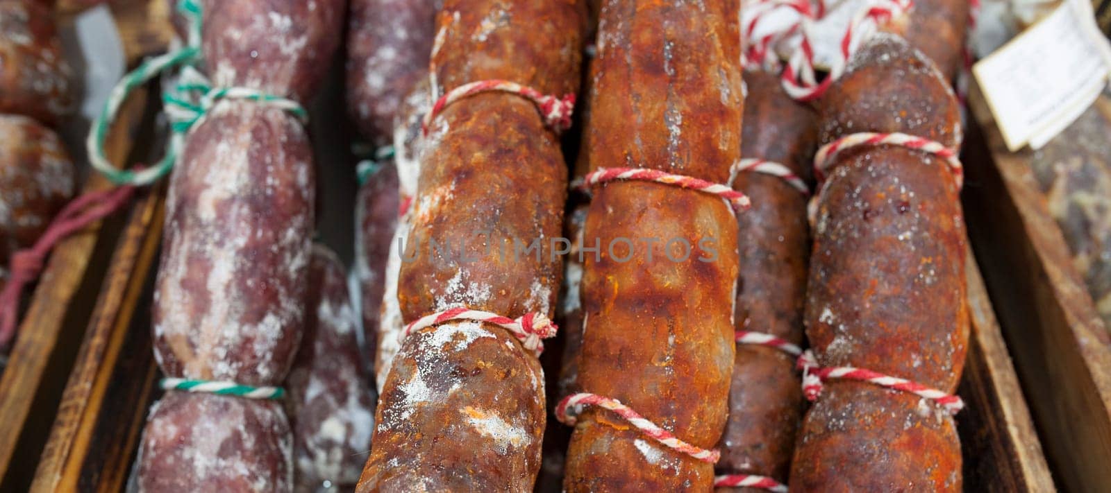 Red and white iberian chorizo displayed at street market stall. Closeup