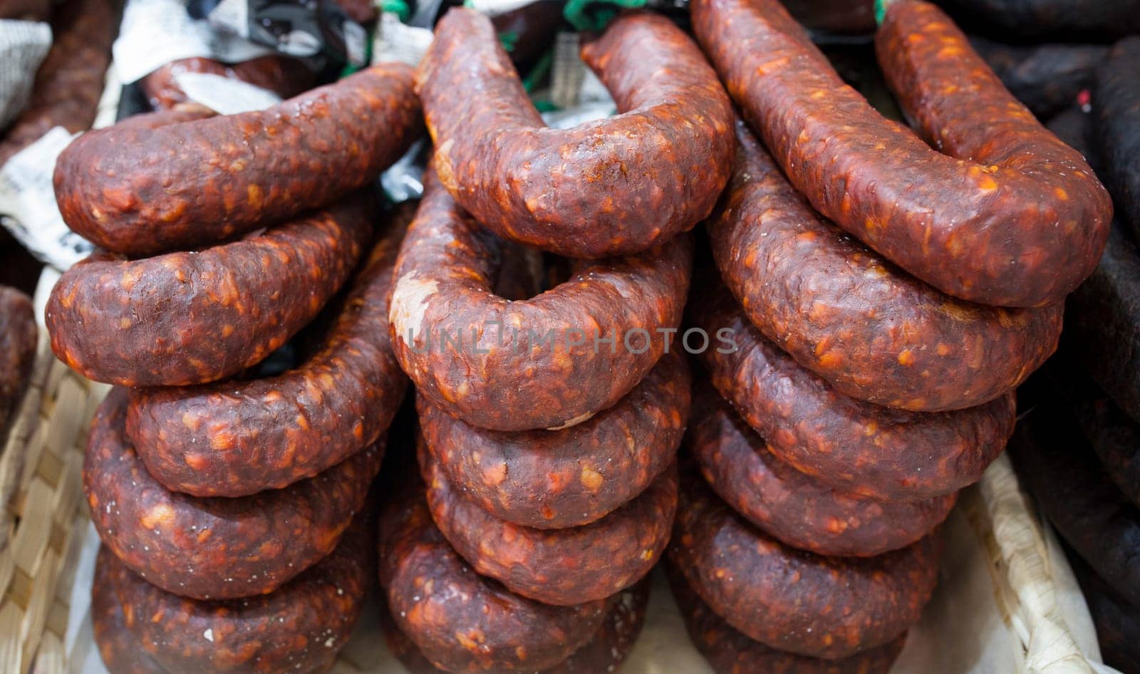 Red iberian chorizo displayed at street market stall. Closeup