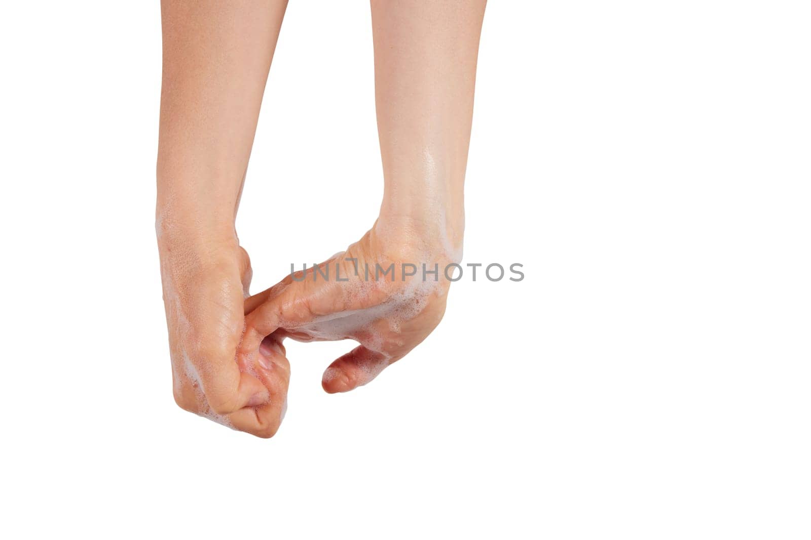 Unrecognizable female lathering wet fingers while washing hands with soap against white background