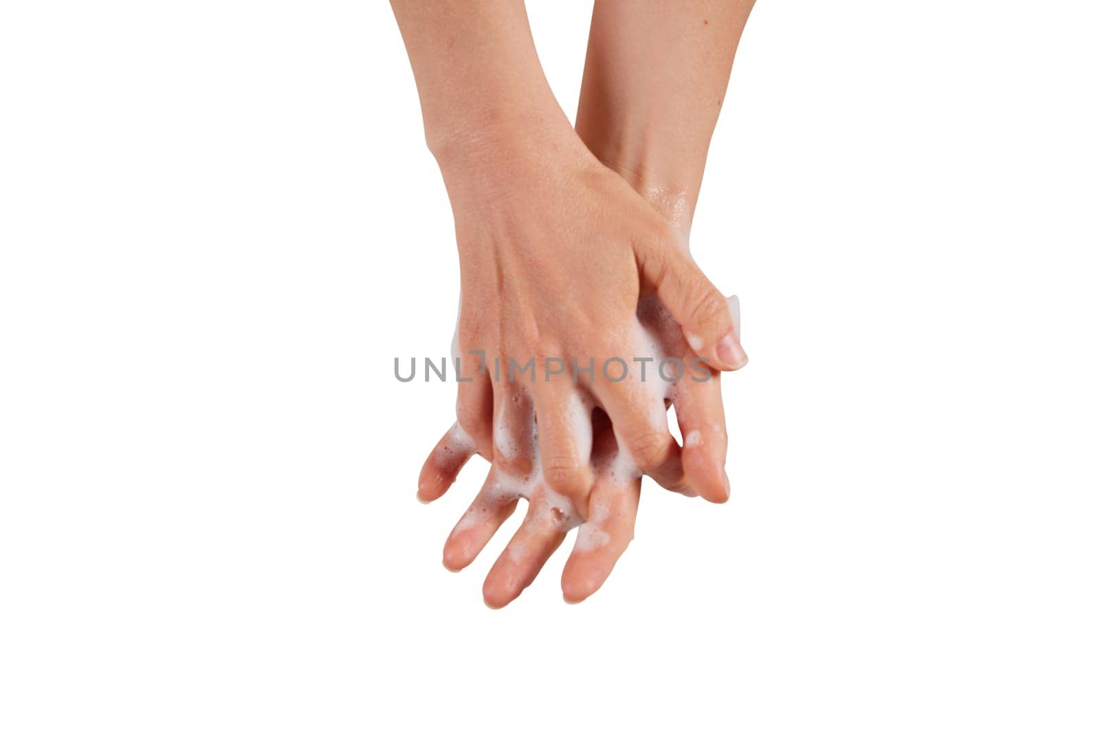 Anonymous female clasping hands and spreading soap foam during hygienic routine against white background