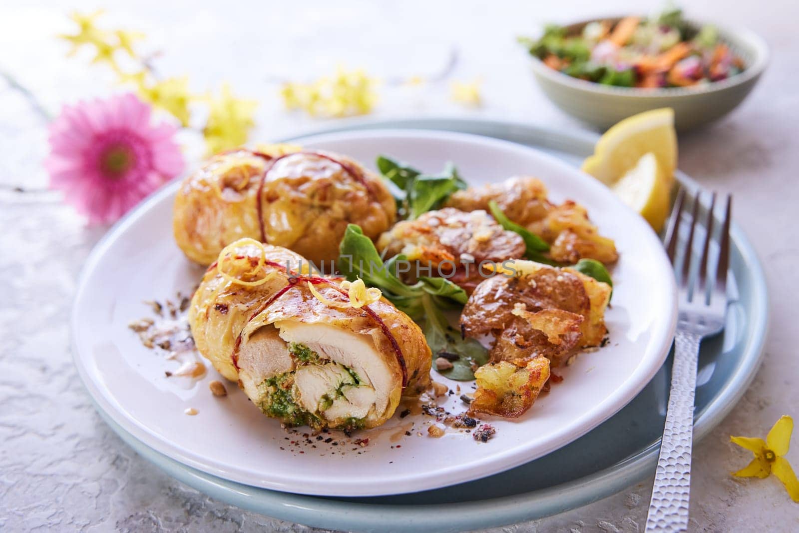 From above of appetizing stuffed chicken thighs served on plate with green herbs for lunch