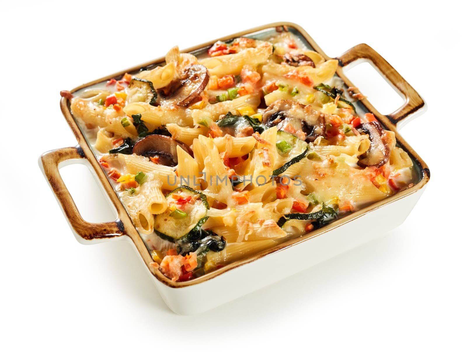 Casserole with delicious baked pasta with cheese and vegetables served for lunch on white background