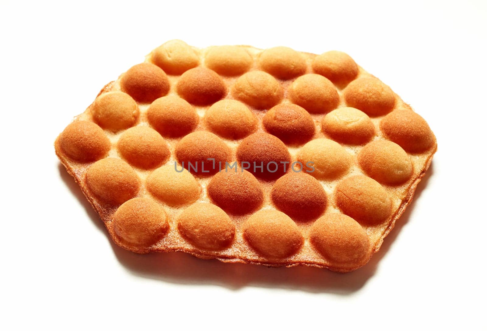 From above of appetizing traditional bubble wafer placed on white background in studio