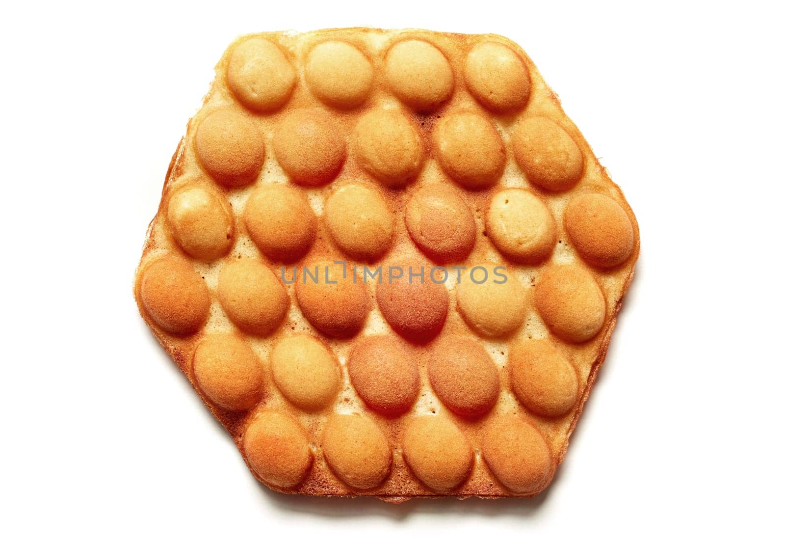 Top view of appetizing hexagon shaped egg wafer dessert placed on white isolated background in studio